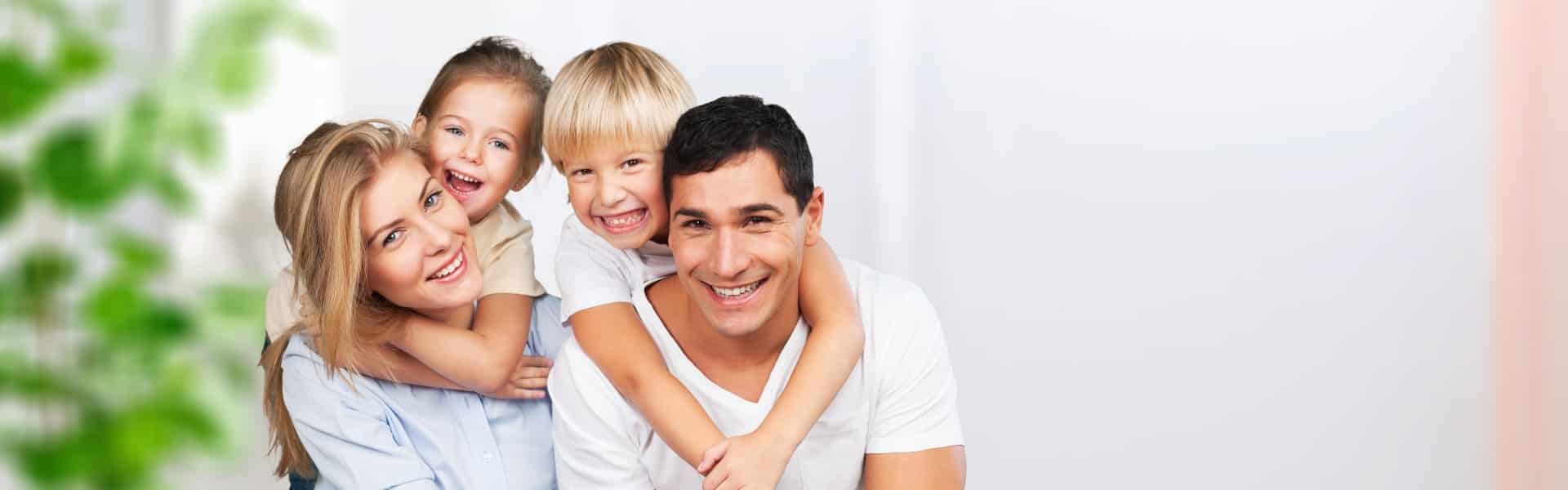 Beautiful smiling family sitting at sofa at home