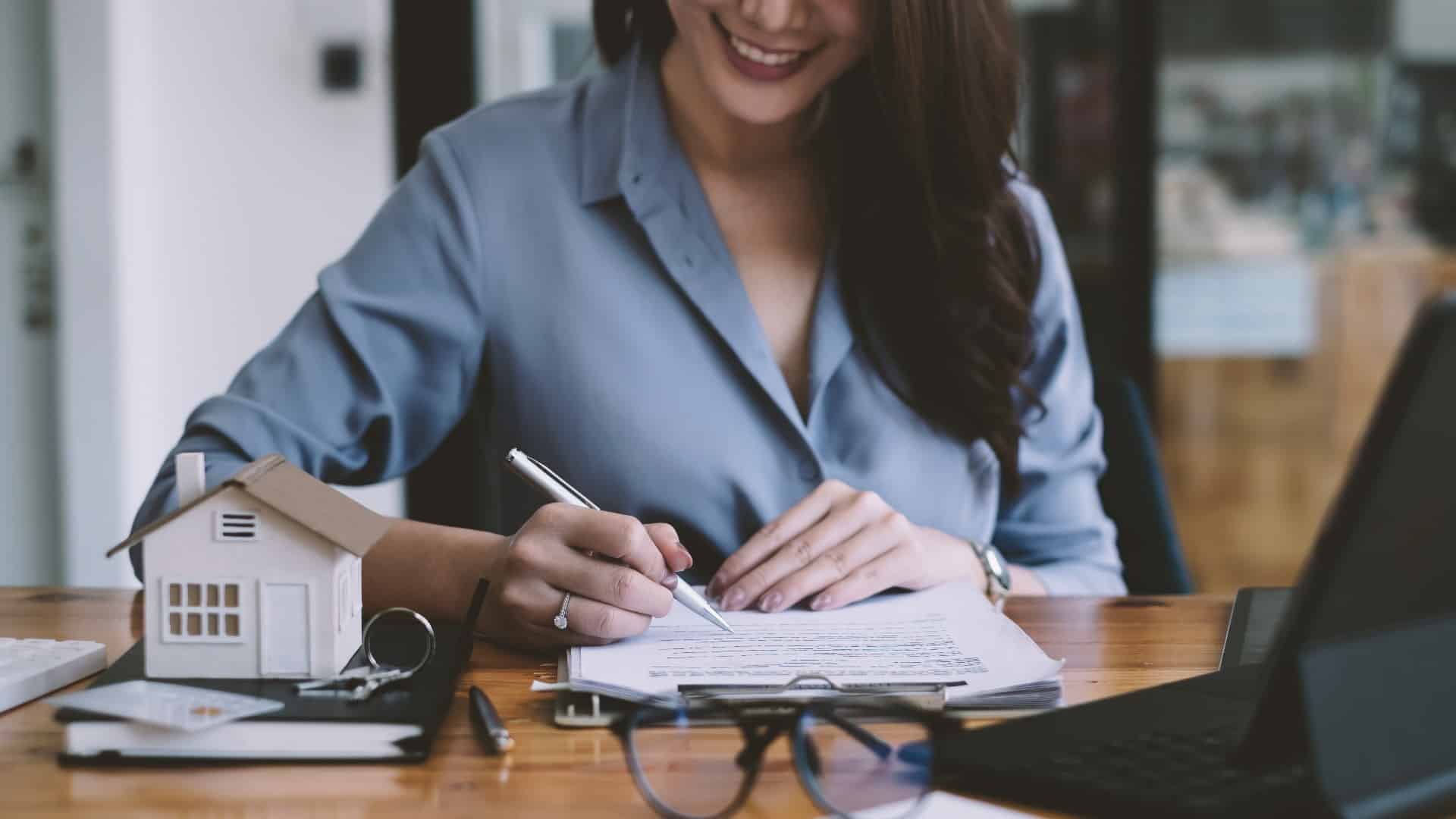 Business woman or broker checking contract agreement paper with customer to sign contract. Real Estate and Agreement concept