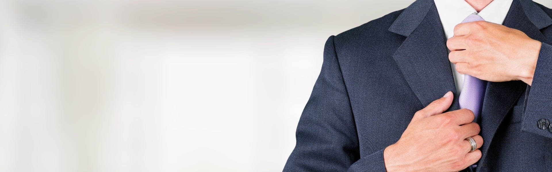 Confident business man wearing elegant suit with hands folded