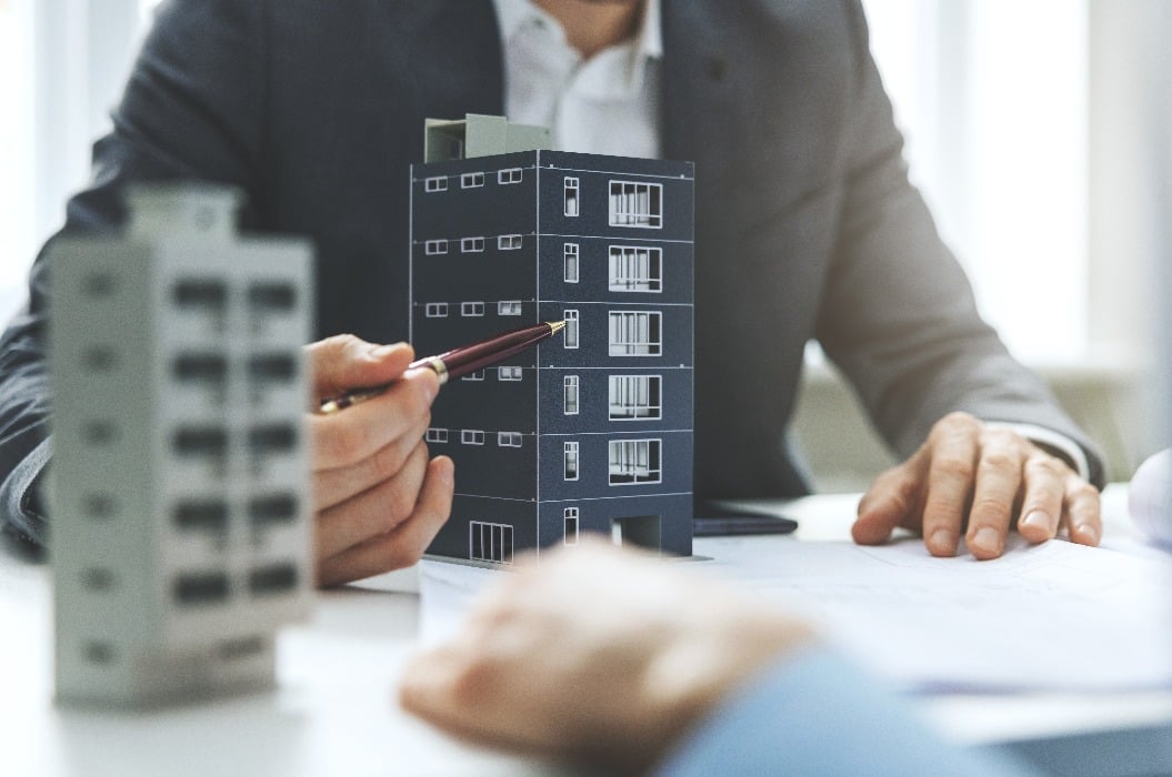 real estate developer and architect discussing new housing development project in office