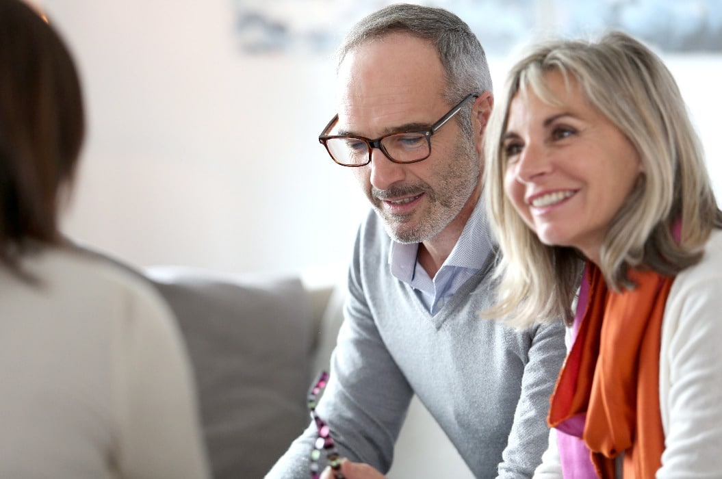 Senior couple meeting financial adviser for investment