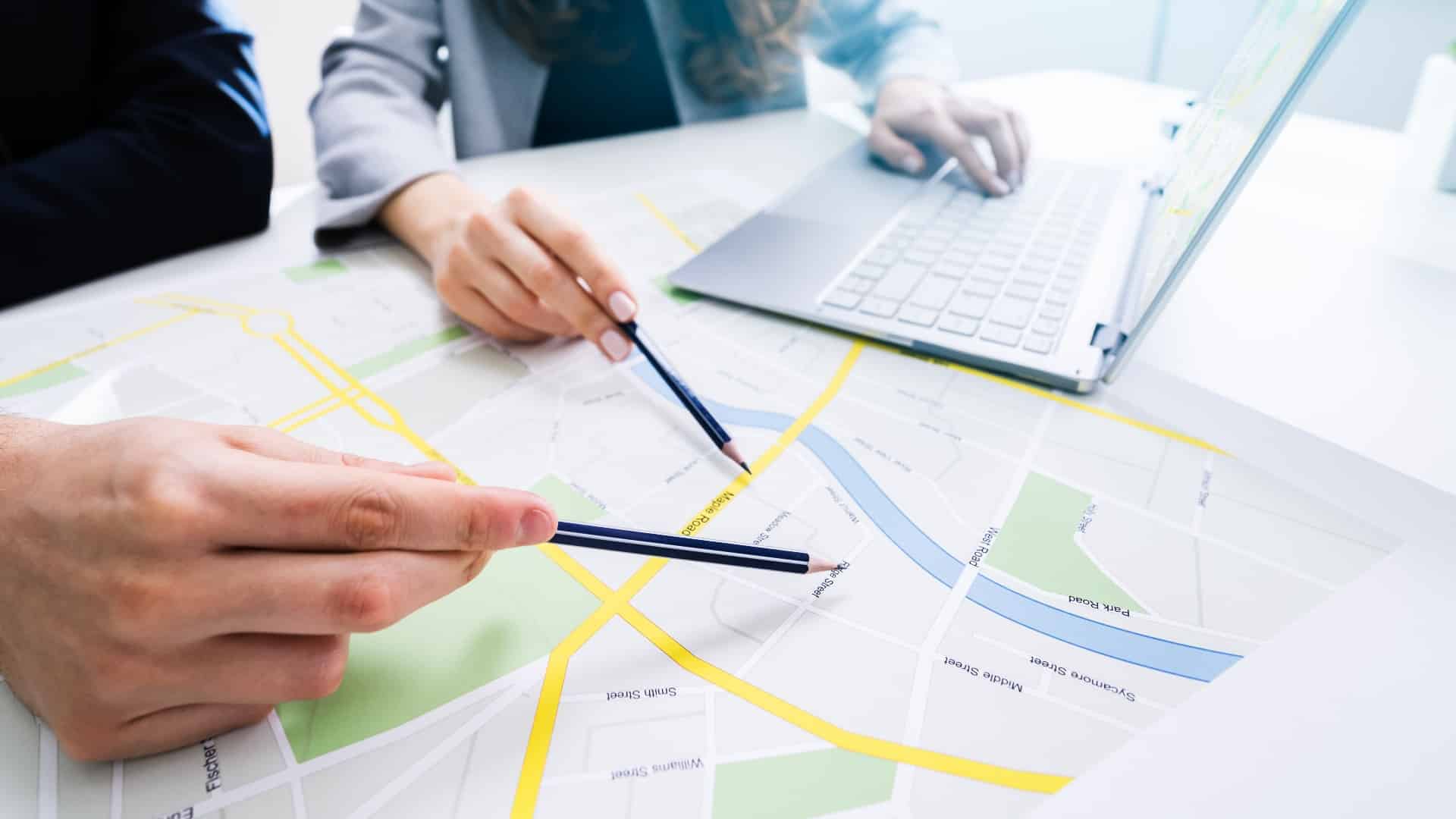 Two People Looking At City Map